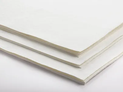 A stack of white paper sheets on a plain surface.